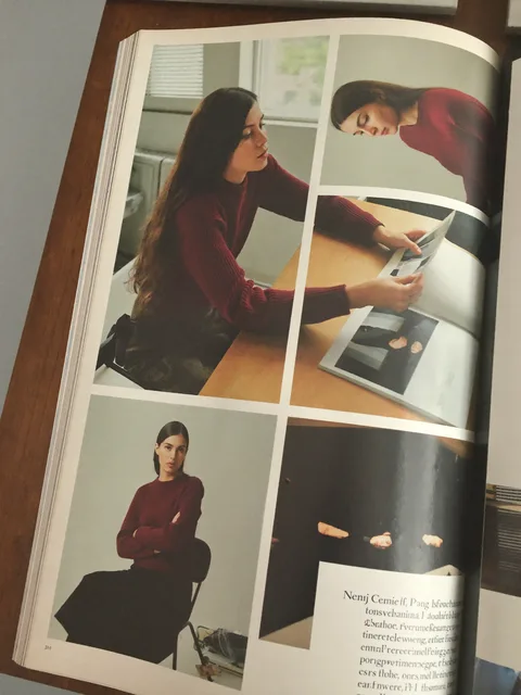 An open fashion magazine spread on a desk